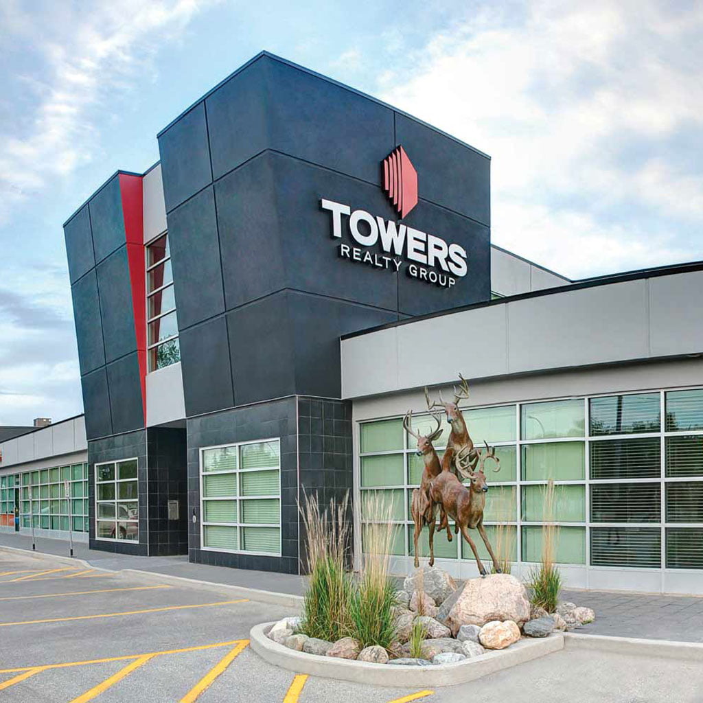 towers realty group building front with running deer statues